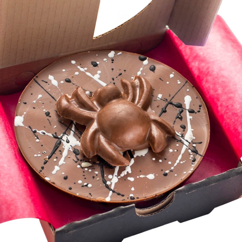 Mini Chocolate Spider Pizza measures approx 4" in diameter and has a milk chocolate spider sitting in the middle.